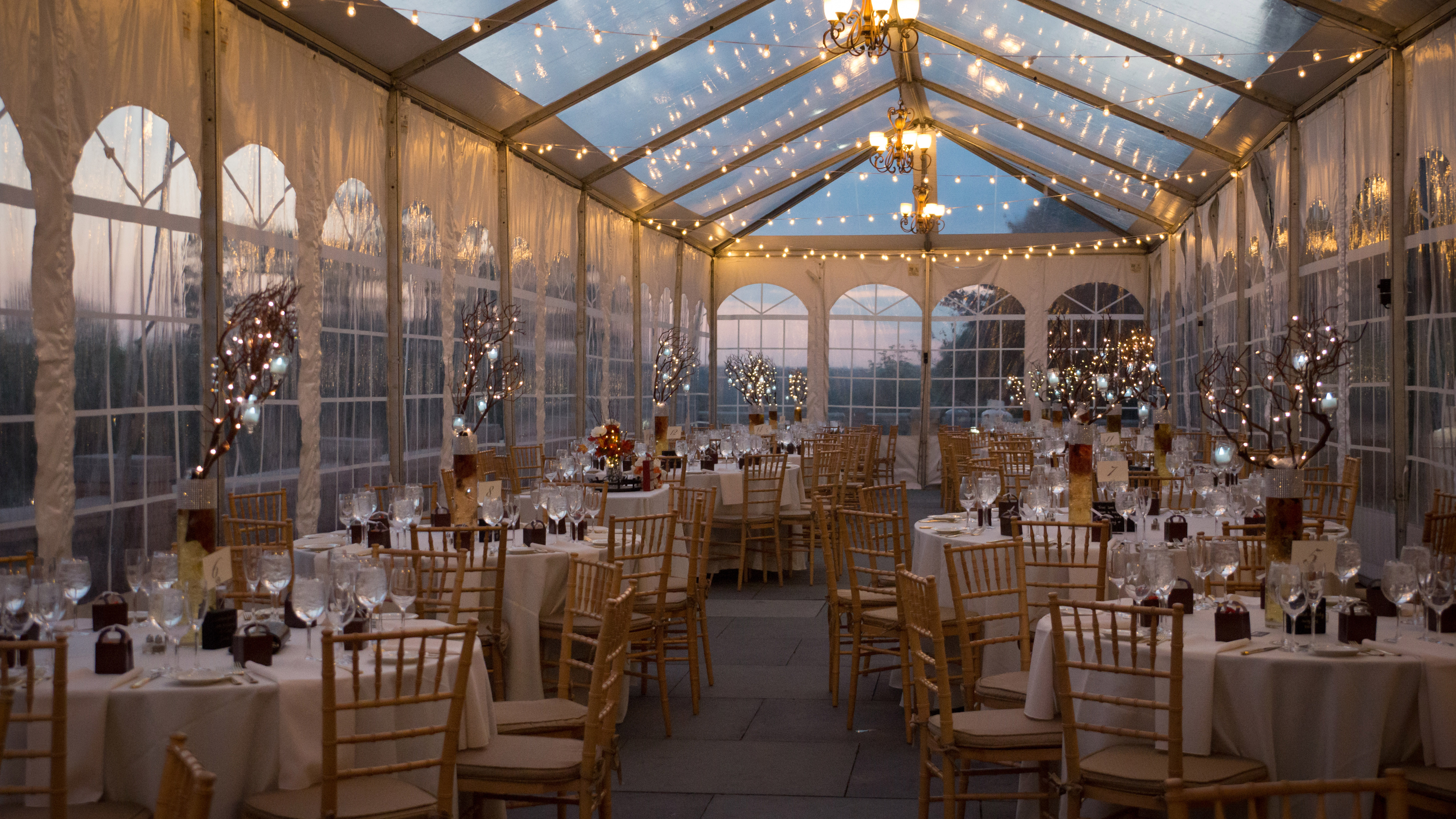 Wedding reception under a warmly lit tent